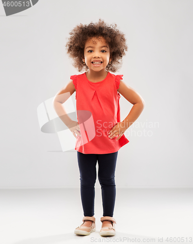 Image of happy little african american girl over grey