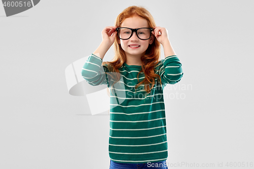 Image of smiling red haired student girl in glasses