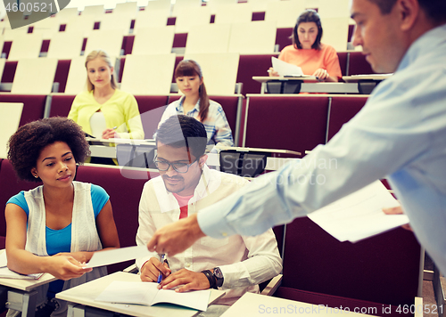 Image of teacher giving tests to students at lecture