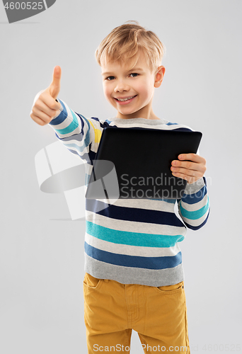 Image of smiling boy with tablet computer showing thumbs up