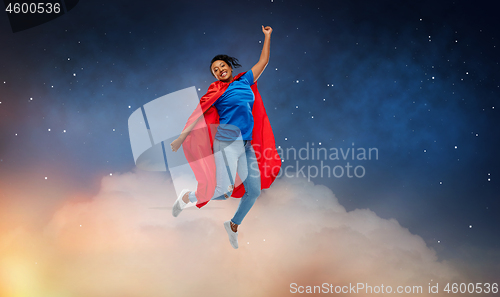 Image of happy african american woman in superhero red cape