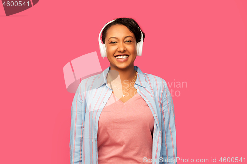 Image of african woman in headphones listening to music