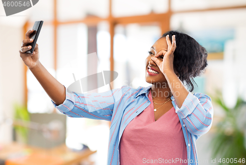 Image of african american woman taking selfie by smartphone