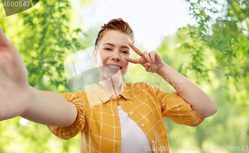 Image of redhead teenage girl taking selfie making peace