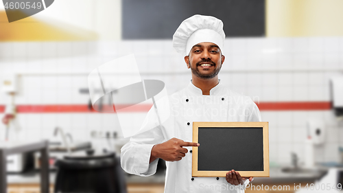 Image of indian chef with chalkboard at restaurant kitchen