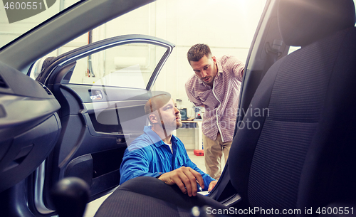 Image of auto mechanic and man at car shop