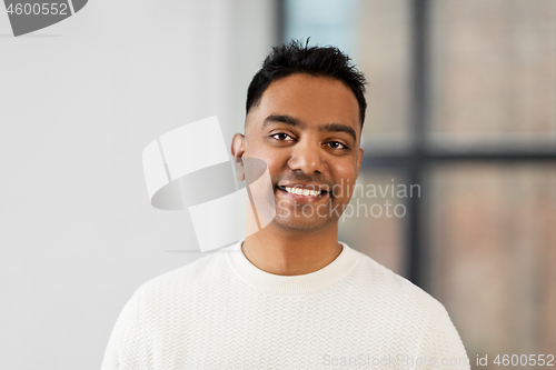 Image of portrait of smiling indian businessman at office