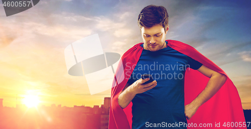 Image of man in red superhero cape using smartphone