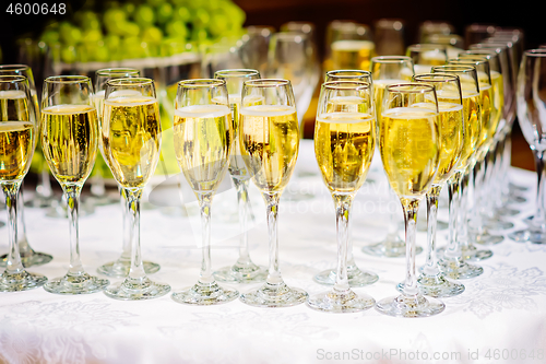 Image of Glasses of champagne waiting for guests, rustic toned