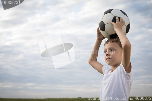 Image of Portrait of a young  boy with soccer ball. 