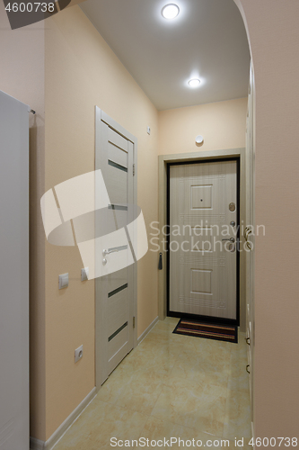 Image of The hallway in the apartment, the front door and the door to the bathroom