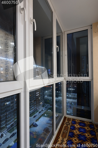 Image of New plastic stained glass windows on the loggia, on the street twilight