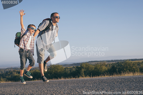 Image of Father and  son playing on the road at the day time.