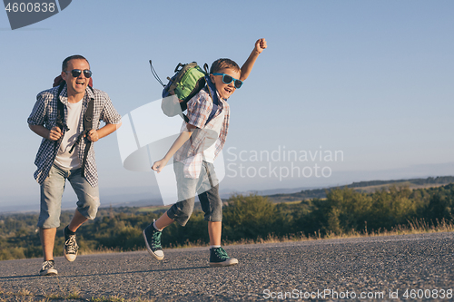 Image of Father and  son playing on the road at the day time.