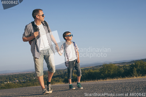 Image of Father and  son playing on the road at the day time.