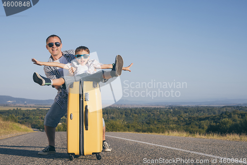 Image of Father and  son playing on the road at the day time.