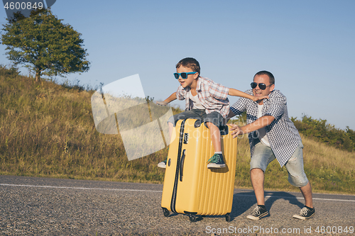 Image of Father and  son playing on the road at the day time.