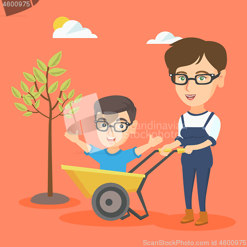 Image of Young mother pushing a wheelbarrow with her son.