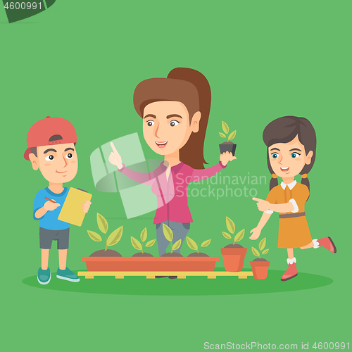 Image of Caucasian teacher and school kids planting sprouts