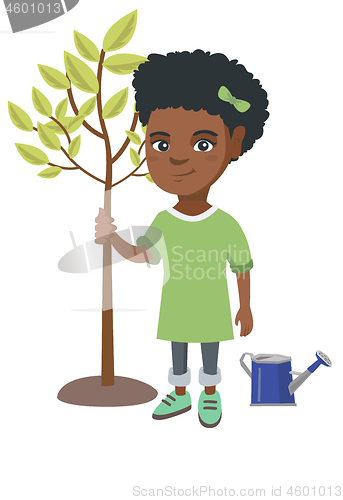 Image of African-american smiling girl planting a tree.