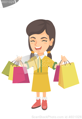 Image of Happy caucasian girl holding shopping bags.