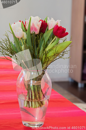 Image of A bouquet of tulips in a vase on the table