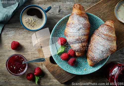 Image of freshly baked croissants on wooden table
