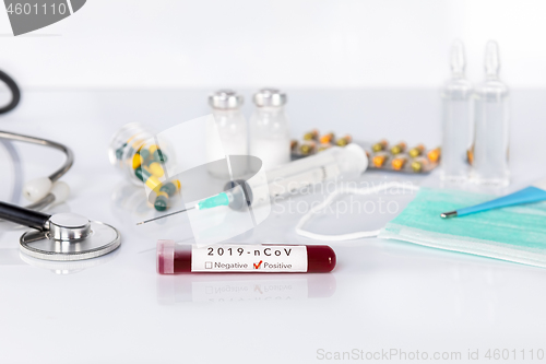 Image of Blood test tube with the Coronavirus disease for virus test and 