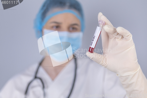 Image of Nurse holding test tube blood sample