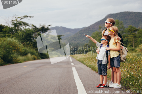 Image of Happy children  walking on the road at the day time.