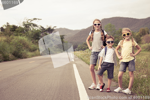 Image of Happy children  walking on the road at the day time. 