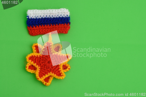 Image of An embroidered order with the flag of Russia on a green background