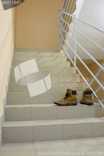 Image of There are discarded boots on the stairs