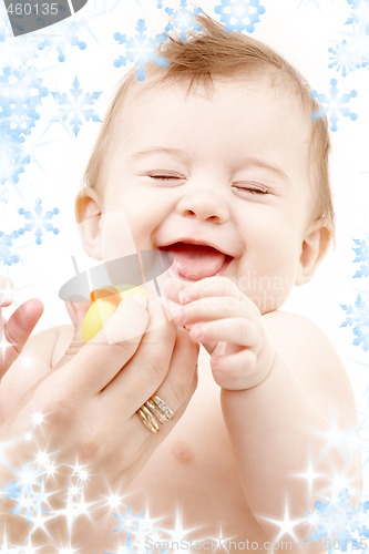 Image of laughing baby boy in mother hands with rubber duck