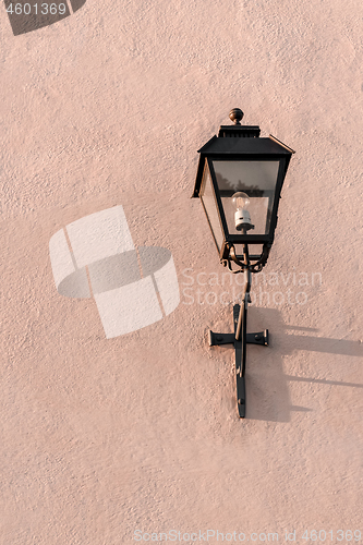 Image of Streetlight on a textured pink wall