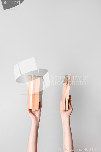 Image of Female hands holding books
