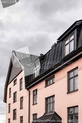 Image of Pastel colored building with black roof