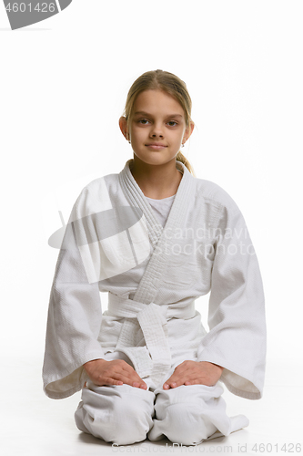 Image of Girl in judo class, sitting on the floor