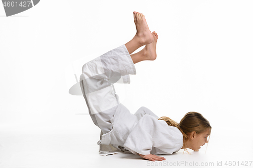 Image of Girl judo student performs warm-up