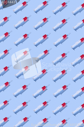 Image of Health-care pattern of disposable syringes with red liquid.