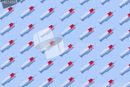 Image of Medical pattern with plastic syringes of red vaccine.