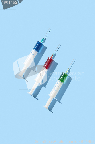 Image of Therapeutic set of plastic syrenges with colorful vaccines.