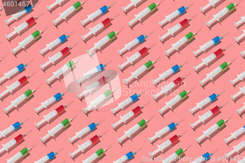 Image of Therapeutic pattern of plastic syrenges with colorful vaccines.