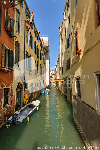 Image of Venice, Italy. Narrow canal in historic part of the city