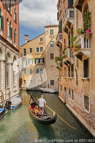 Image of Venice, Italy. Tourists riding gondolas