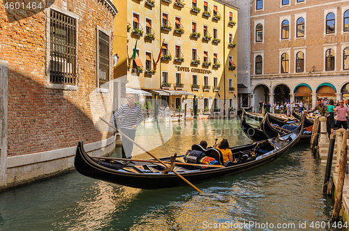 Image of Venice, Italy. Tourists riding gondolas