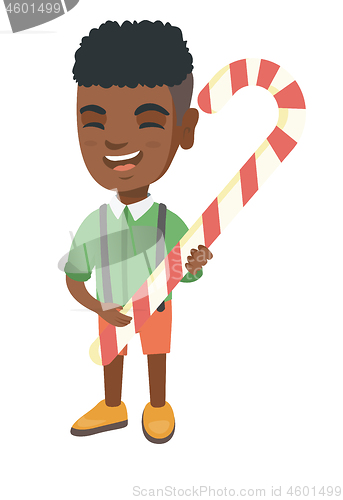 Image of African little boy holding christmas candy cane.