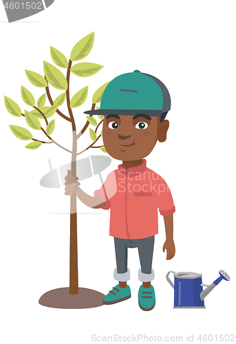 Image of African-american smiling boy planting a tree.