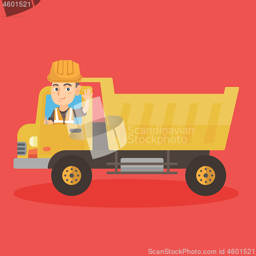 Image of Little caucasian driver driving a dump truck.