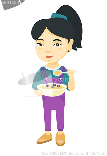 Image of Little girl drinking soda and eating cheeseburger.